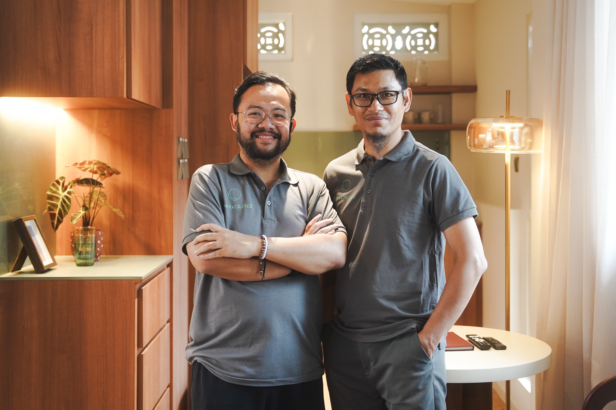 Two members of the CM Facilities team in company uniforms
